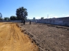 Workers clear more land by hand.